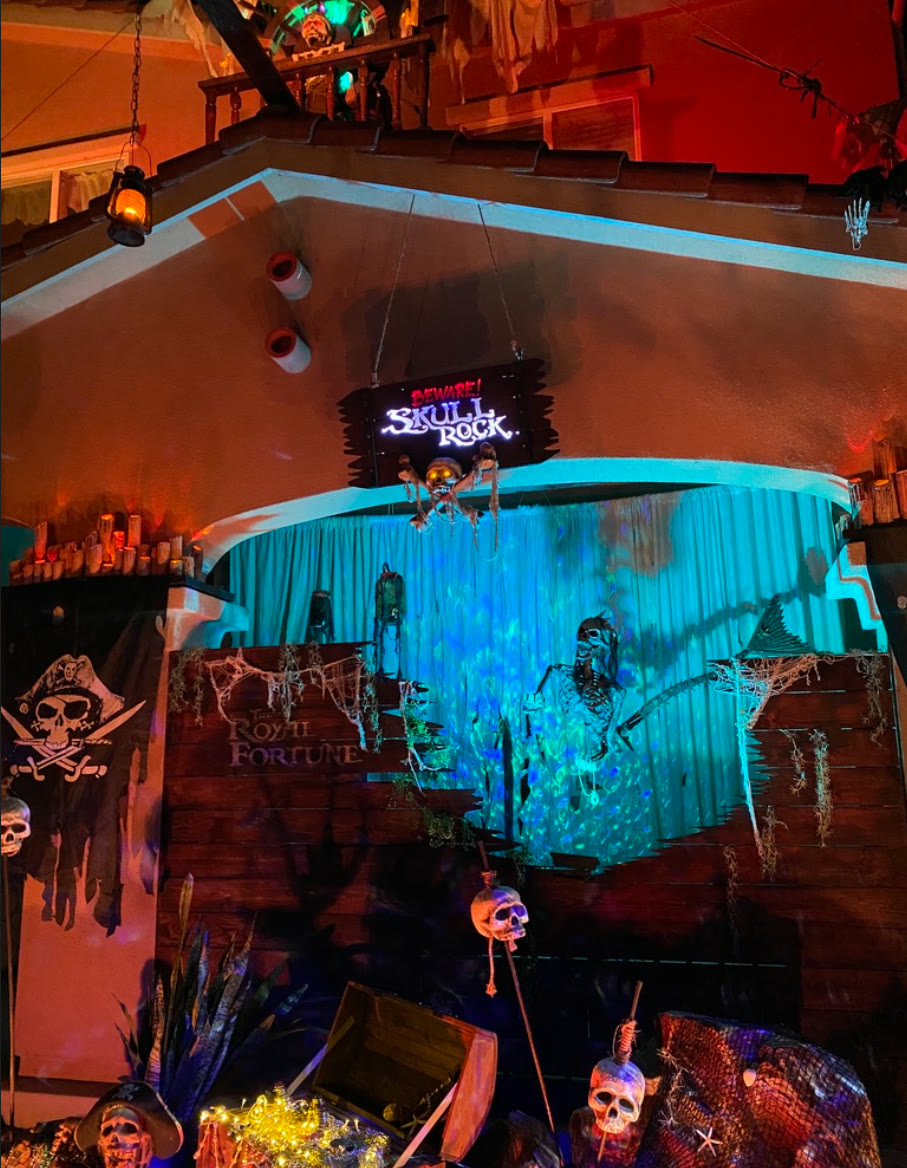 The Royal Fortune shipwreck beneath the illuminated Skull Rock sign